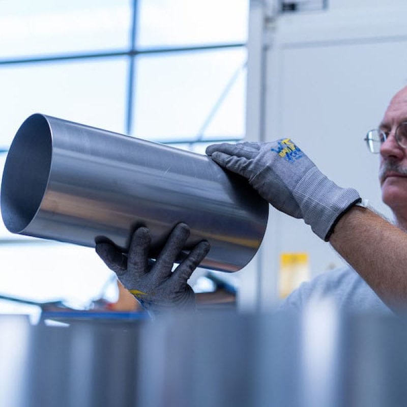 Mitarbeiter bei de Sichtung eines Blechrohres
